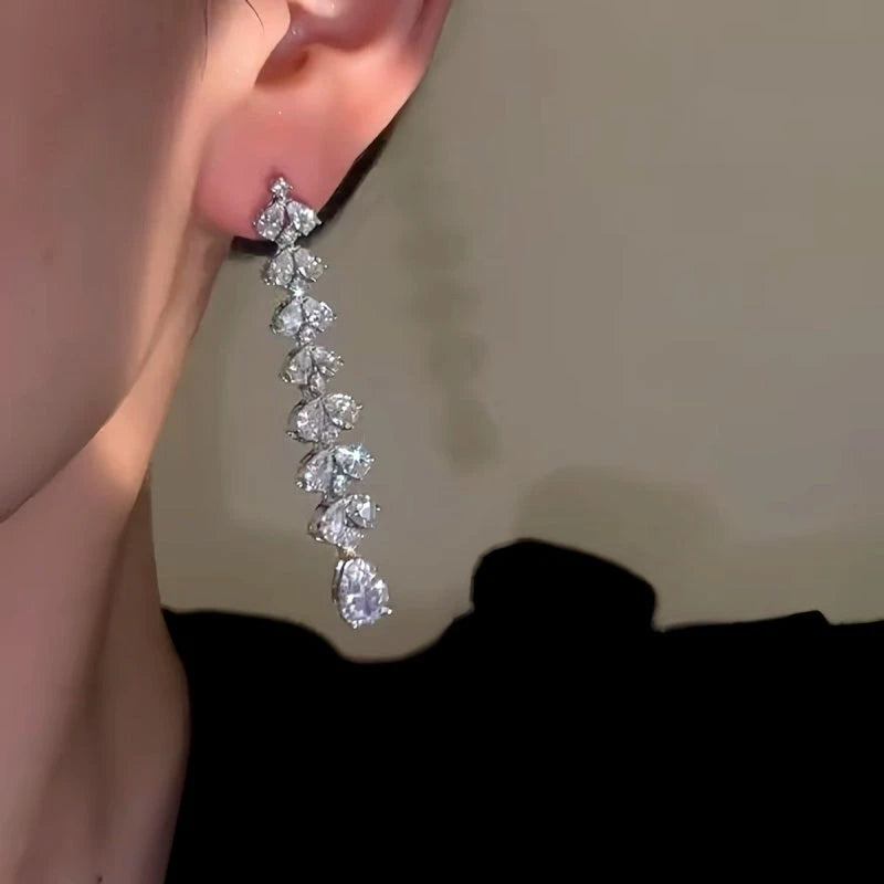 Model showcasing the dangle and style of the 14K Gold-Plated Flower Water Drop Earrings