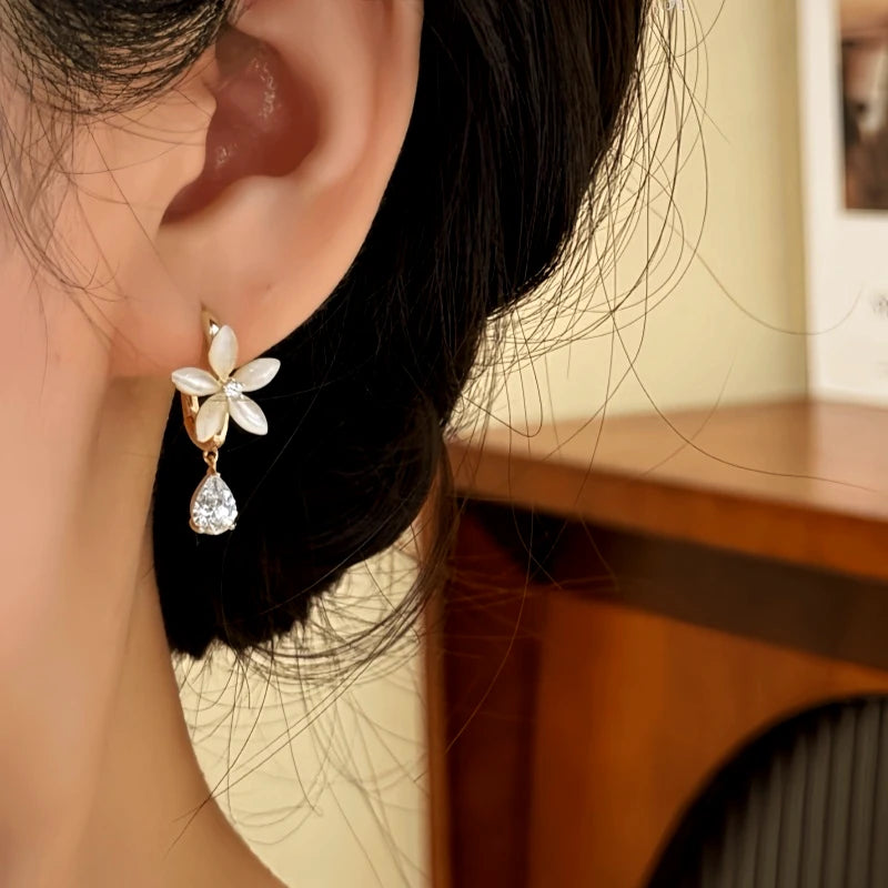 Close-up detail of the sparkling zircons and plating on the Gold Flower Drop Earrings
