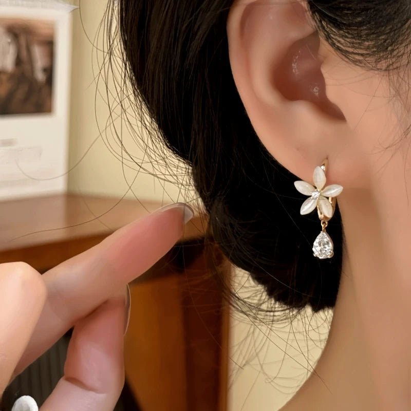 Angled view of the 14K Gold-Plated Flower Water Drop Earrings
