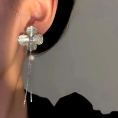 Close-up detail of the sparkling zircons and plating on the Clover Tassel Earrings