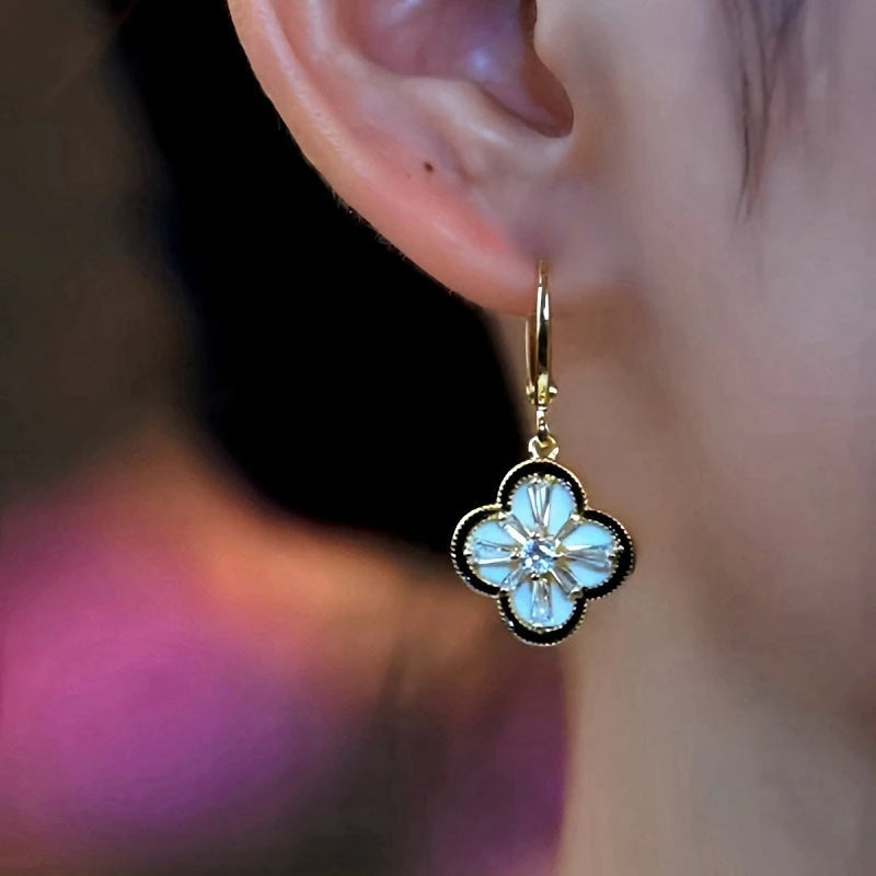 Close-up detail of the sparkling zircons and plating on the Clover Dangle Earrings