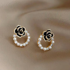 Model showcasing the dangle and style of the 14K Gold-Plated French Camellia Pearl Zircon Earrings
