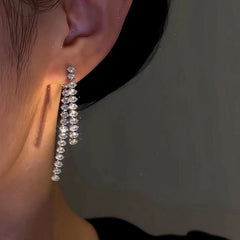 Model showcasing the dangle and style of the 14K Gold-Plated Front And Back Zircon Tassel Earrings