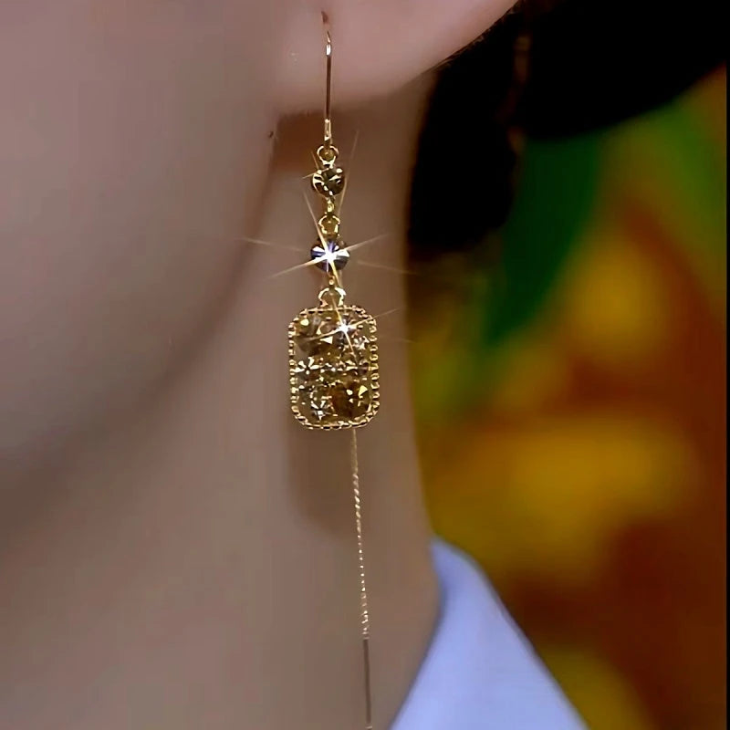 Model showcasing the dangle and style of the 14K Gold-Plated Full Diamond Geometric Square Long Threader Tassel Earrings