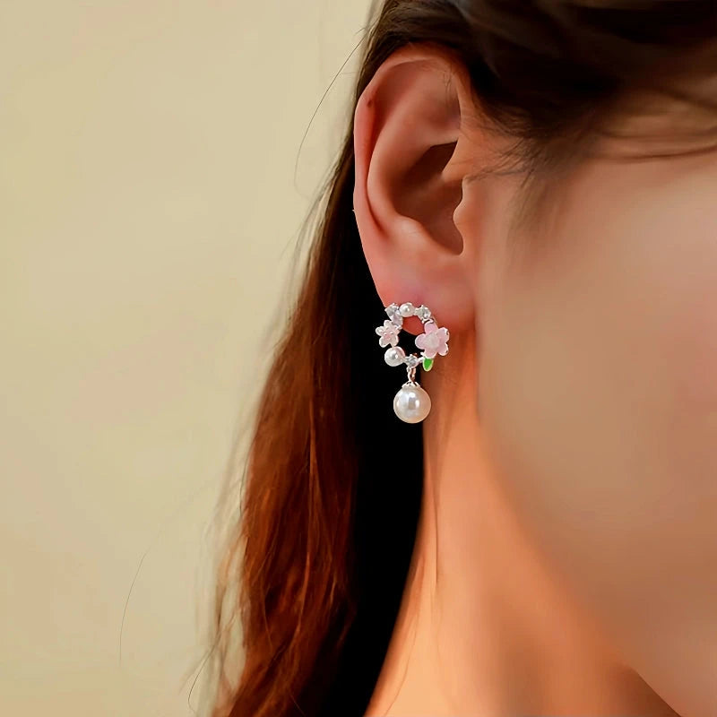 Model showcasing the dangle and style of the 14K Gold-Plated Garland Pearl Earrings