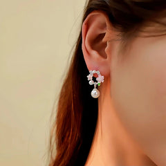 Model showcasing the dangle and style of the 14K Gold-Plated Garland Pearl Earrings