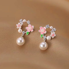 Close-up detail of the sparkling zircons and plating on the Garland Pearl Earrings