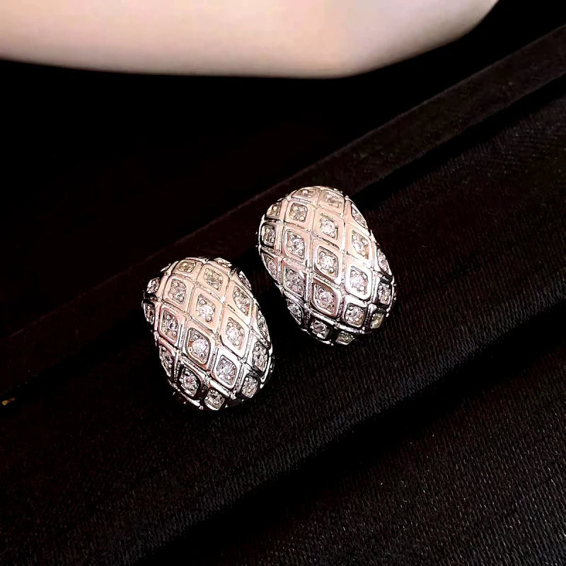 Model showcasing the dangle and style of the 14K Gold-Plated Geometric Diamond C-Shaped Earrings