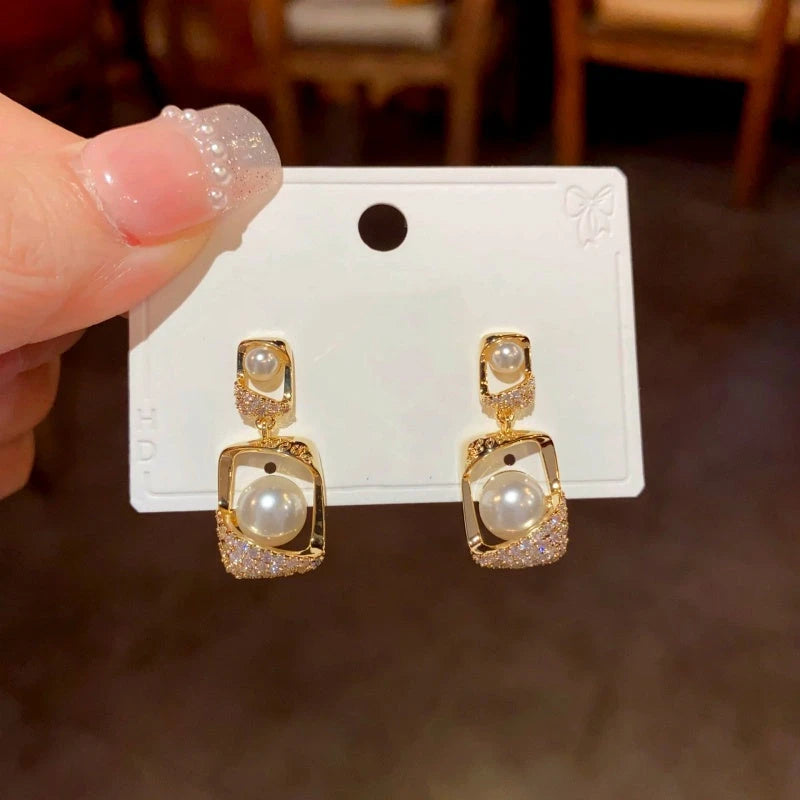 Angled view of the 14K Gold-Plated Geometric Pearl Earrings