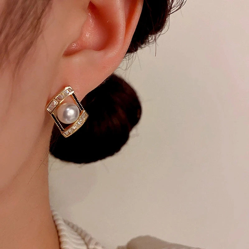 Model showcasing the dangle and style of the 14K Gold-Plated Geometric Zircon Pearl Earrings