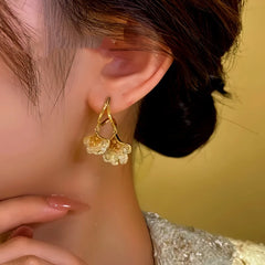 Model showcasing the dangle and style of the 14K Gold-Plated Ginkgo Leaf Earrings