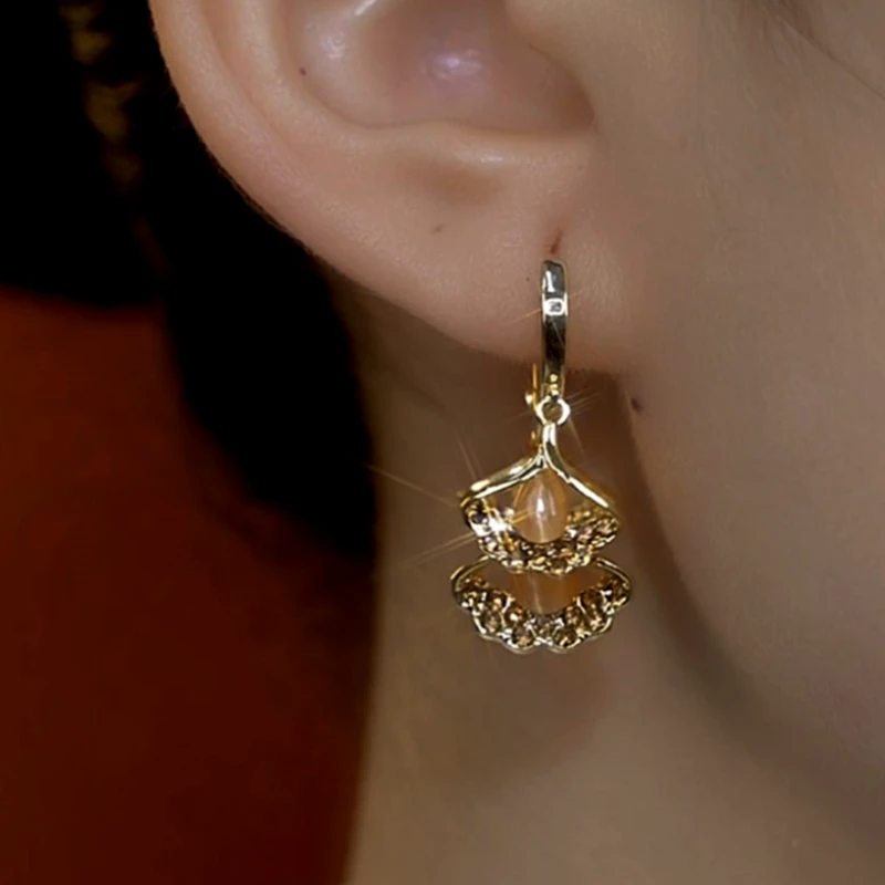Model showcasing the dangle and style of the 14K Gold-Plated Ginkgo Leaf Tassel Earrings