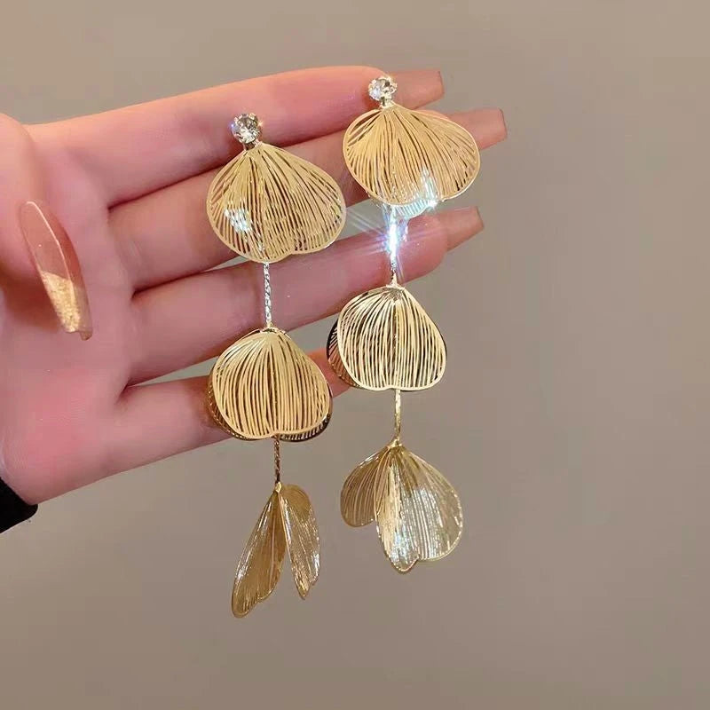 Angled view of the 14K Gold-Plated Ginkgo Leaf Tassel Earrings