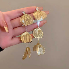 Angled view of the 14K Gold-Plated Ginkgo Leaf Tassel Earrings