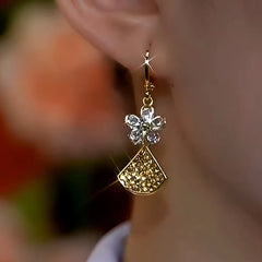 Model showcasing the dangle and style of the 14K Gold-Plated Ginkgo Leaf earrings
