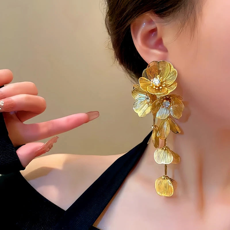 Model showcasing the dangle and style of the 14K Gold-Plated Golden Flower Tassel Earrings