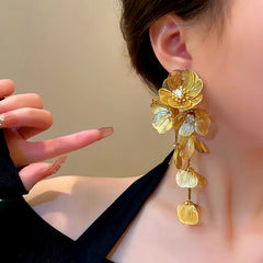 Model showcasing the dangle and style of the 14K Gold-Plated Golden Flower Tassel Earrings