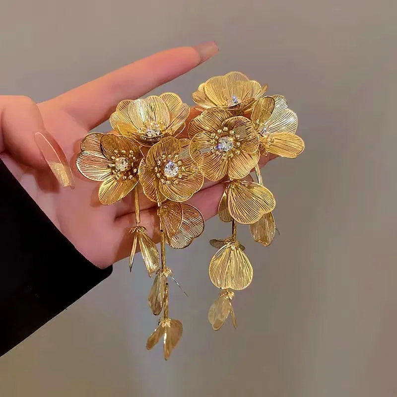 Angled view of the 14K Gold-Plated Golden Flower Tassel Earrings