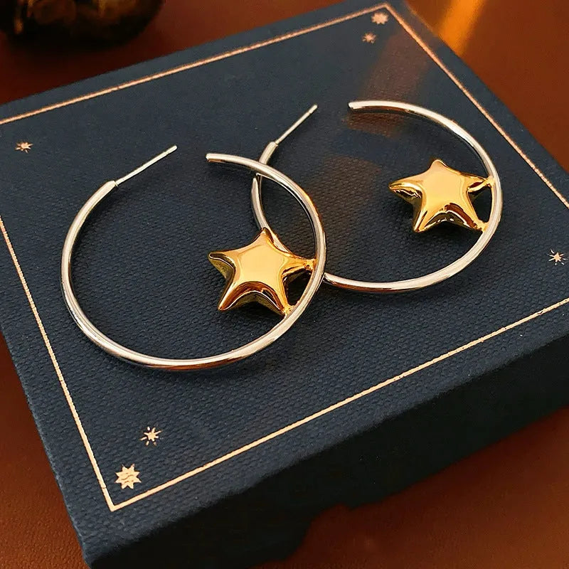 Model showcasing the dangle and style of the 14K Gold-Plated Golden Star Hoop Earring
