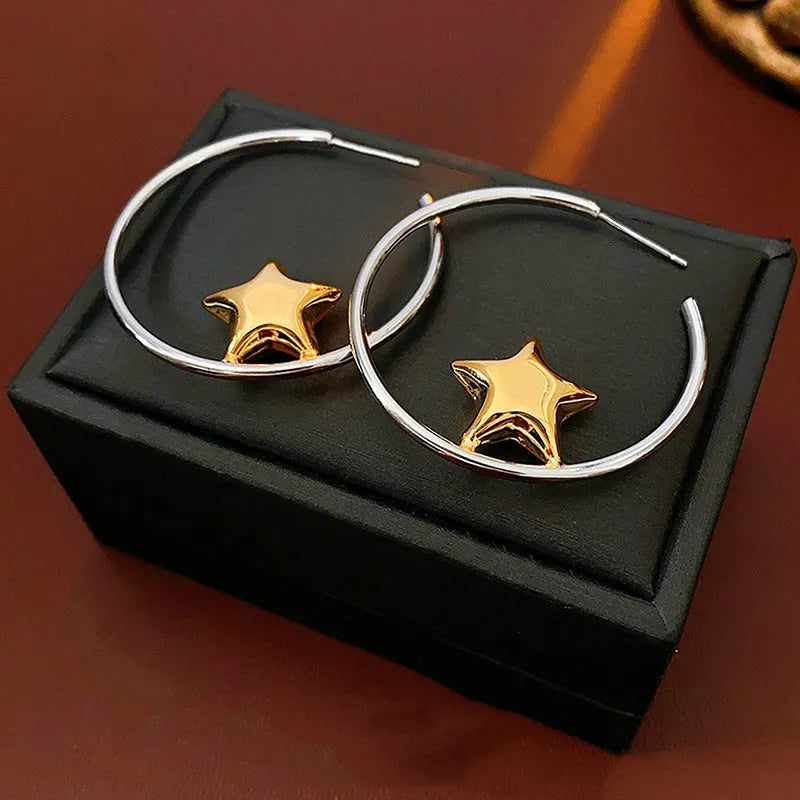 Close-up detail of the sparkling zircons and plating on the Star Hoop Earrings