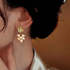 Close-up detail of the sparkling zircons and plating on the Pearl Grape Tassel