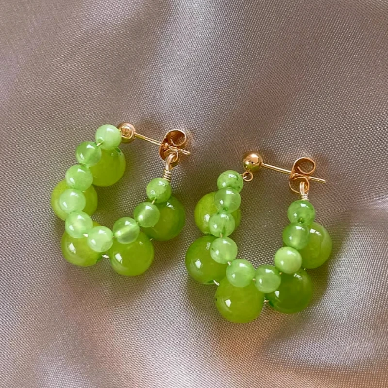 Angled view of the 14K Gold-Plated Green Bead Earrings