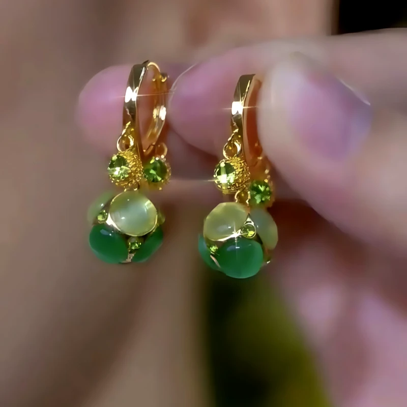 Close-up detail of the sparkling zircons and plating on the Cat's Eye Tassel Earrings