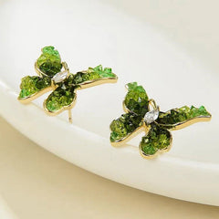 Model showcasing the dangle and style of the 14K Gold-Plated Green Crystal Butterfly Stud Earrings