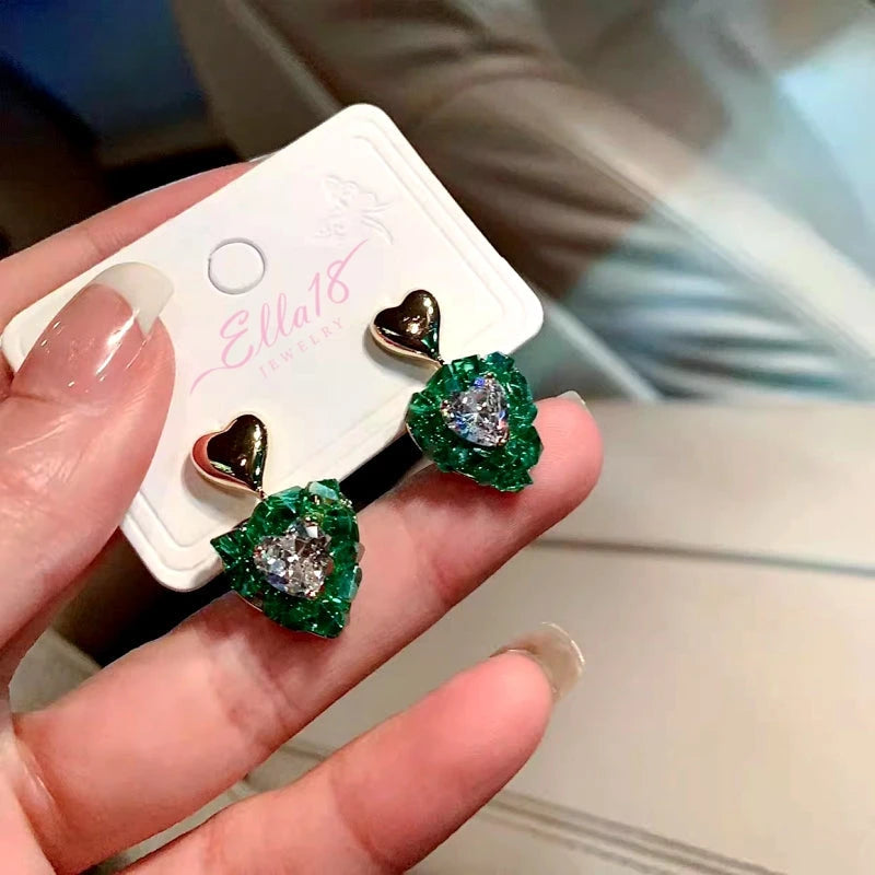 Close-up detail of the sparkling zircons and plating on the Green Heart Earrings