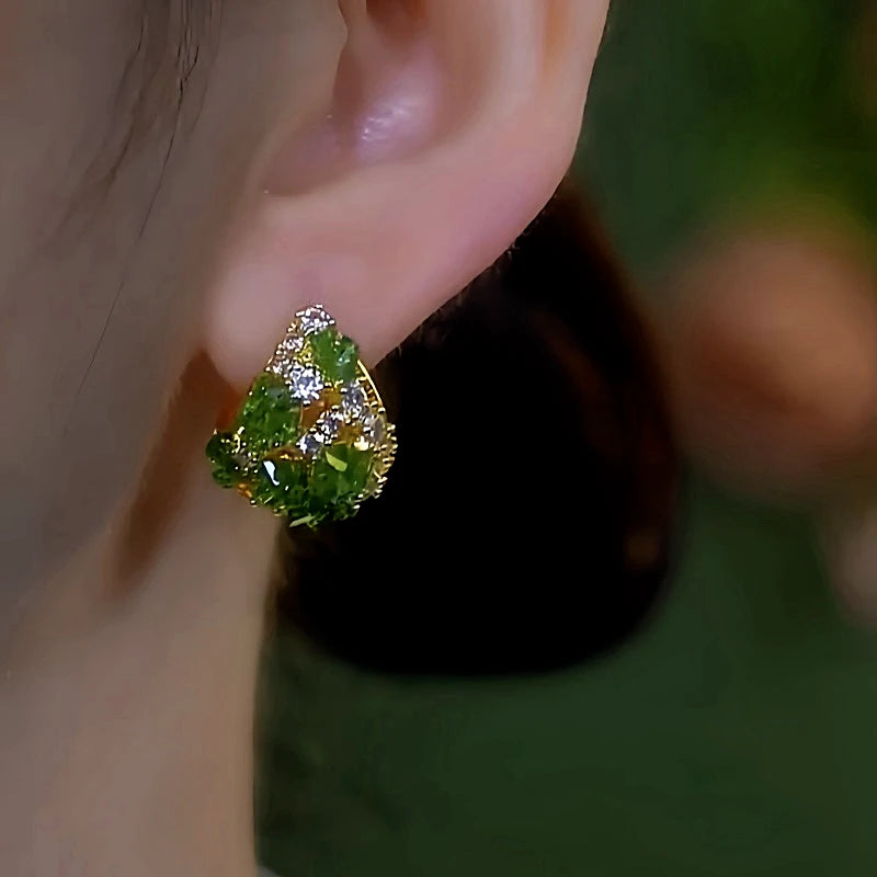 Model showcasing the dangle and style of the 14K Gold-Plated Green Crystals Diamond Earrings