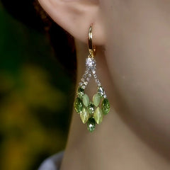 Model showcasing the dangle and style of the 14K Gold-Plated Green Diamond Double-Layer Water Drop Earrings