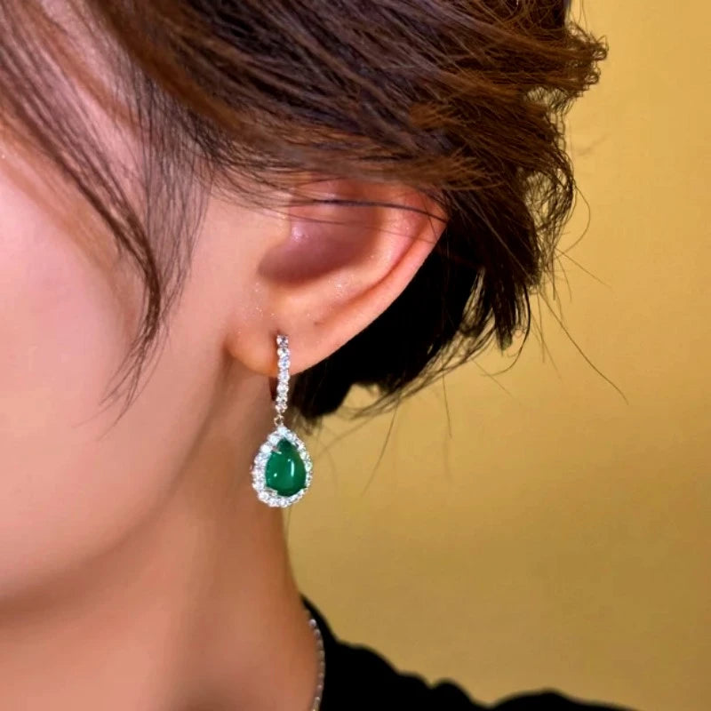 Model showcasing the dangle and style of the 14K Gold-Plated Green Diamond Water Drop Earrings