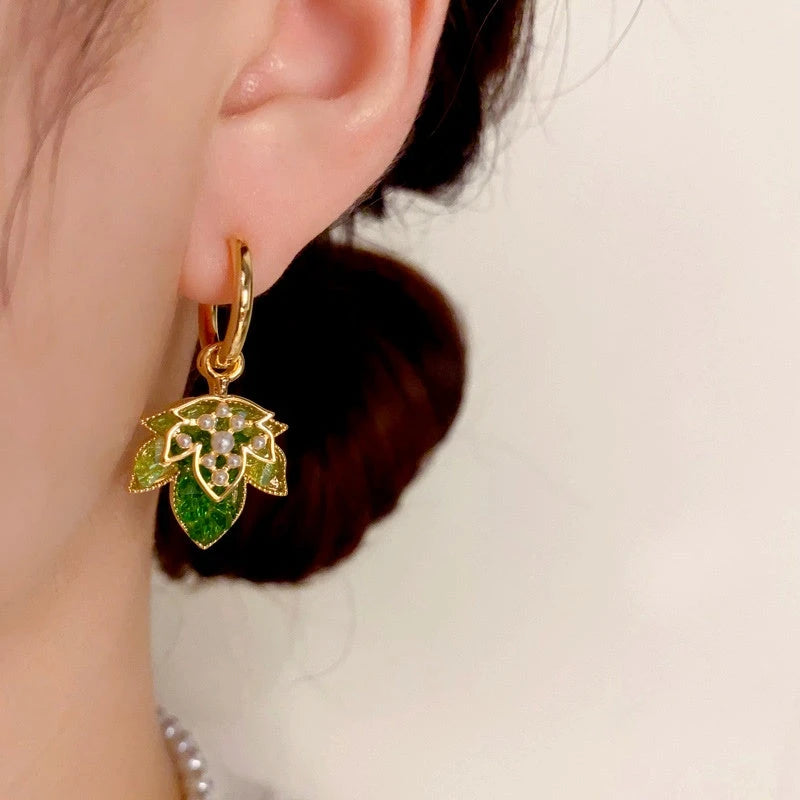 Close-up detail of the sparkling zircons and plating on the Maple Leaf Earrings