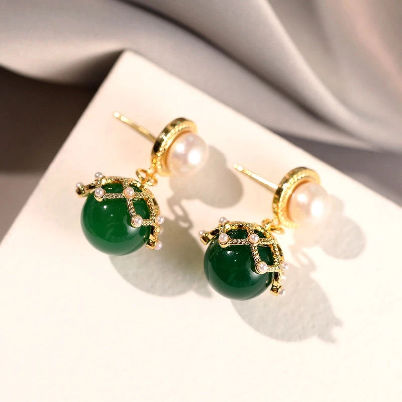 Angled view of the 14K Gold-Plated Green Pearl Earrings