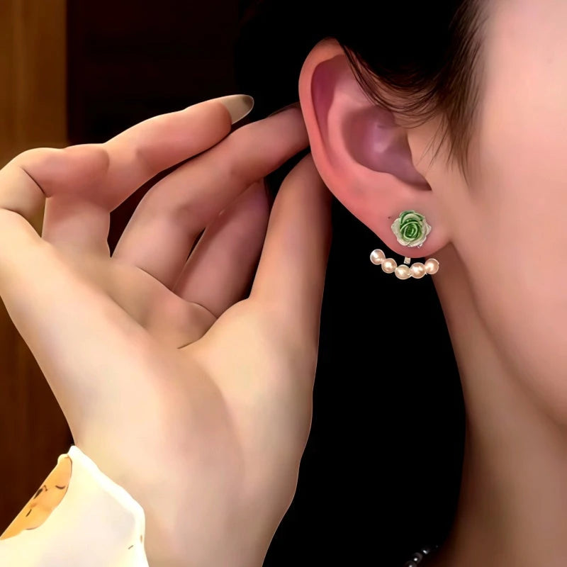 Model showcasing the dangle and style of the 14K Gold-Plated Green Rose Pearl Jacket Earrings