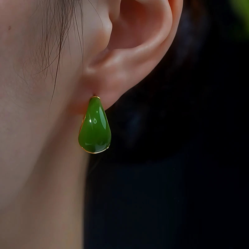 Model showcasing the dangle and style of the 14K Gold-Plated Green Water Drop Earrings