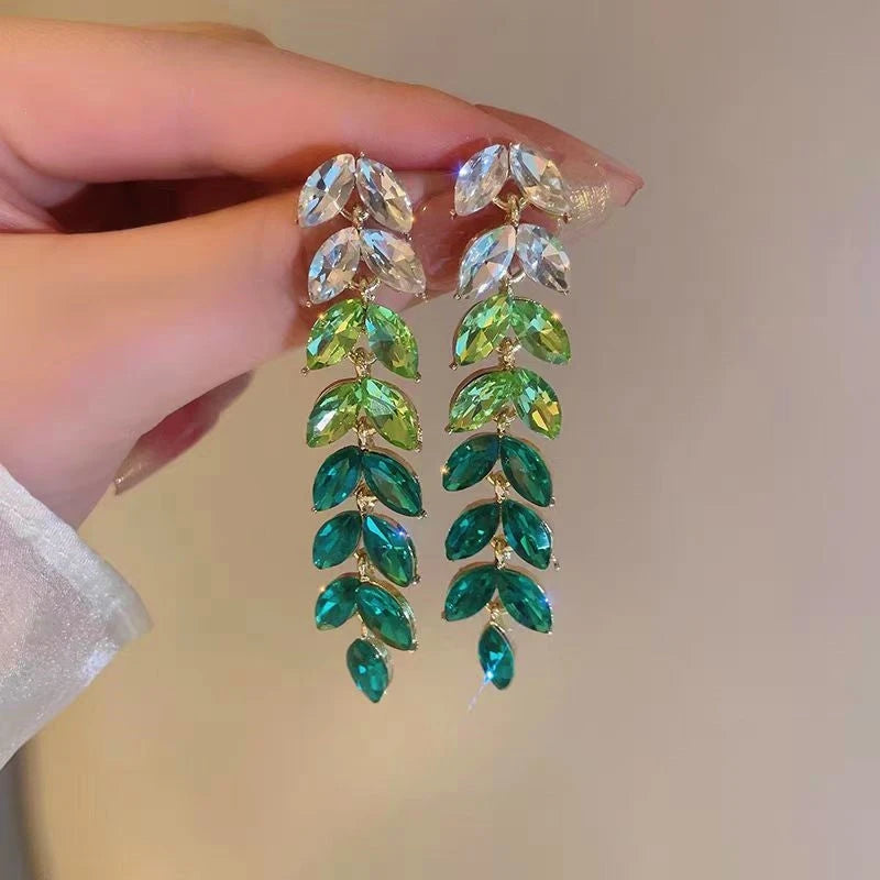 Angled view of the 14K Gold-Plated Green Wheat Tassel Earrings