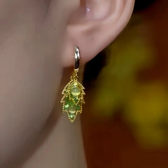 Model showcasing the dangle and style of the 14K Gold-Plated Green Zircon Diamond Cat's Eye Stone Double-Leaf Earrings