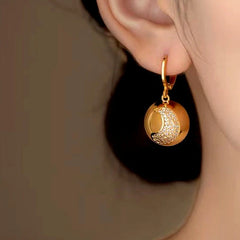 Model showcasing the dangle and style of the 14K Gold-Plated Half-Circle Crescent Earrings