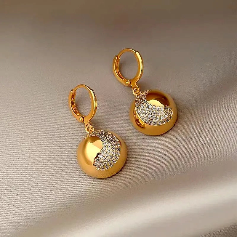 Close-up detail of the sparkling zircons and plating on the Crescent Dangle Earrings