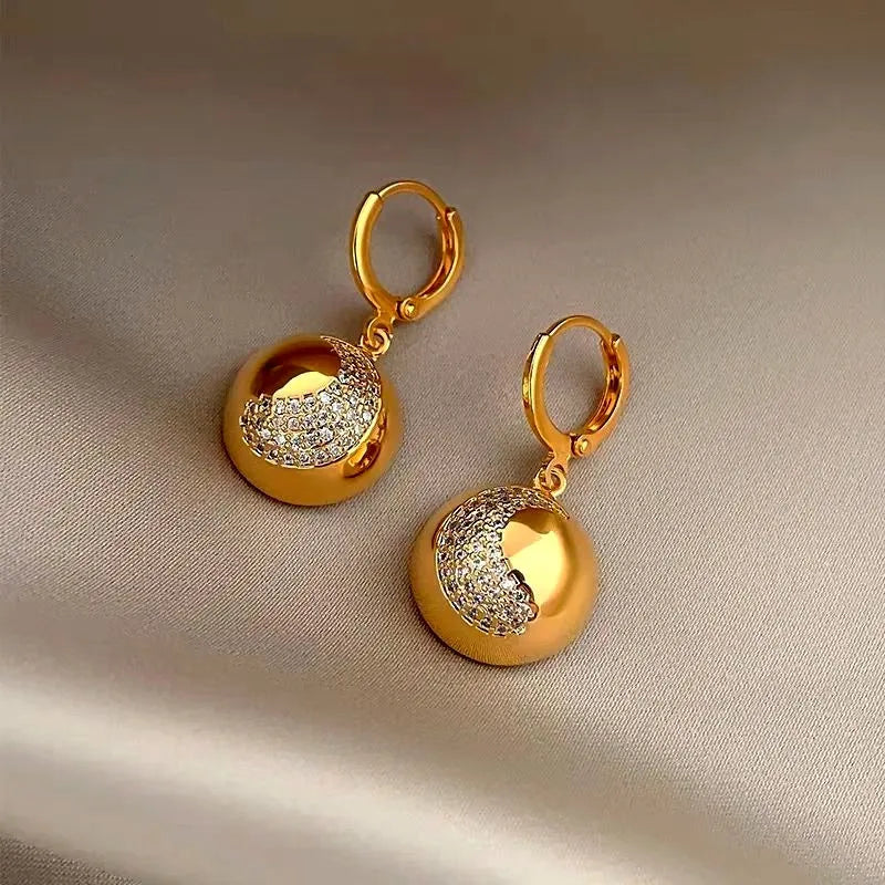 Angled view of the 14K Gold-Plated Half-Circle Crescent Earrings