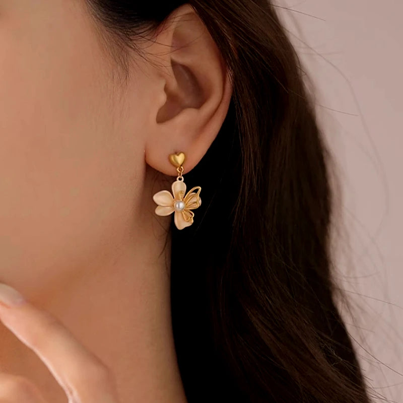 Angled view of the 14K Gold-Plated Heart-Design Flower Earrings
