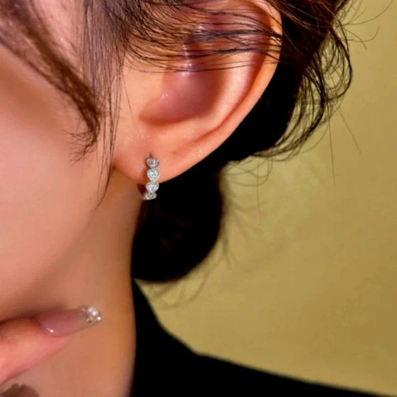 Close-up detail of the sparkling zircons and plating on the Heart Charm Hoops