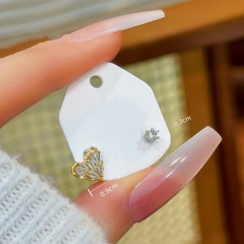 Angled view of the 14K Gold-Plated Heart-Design Stud Earrings