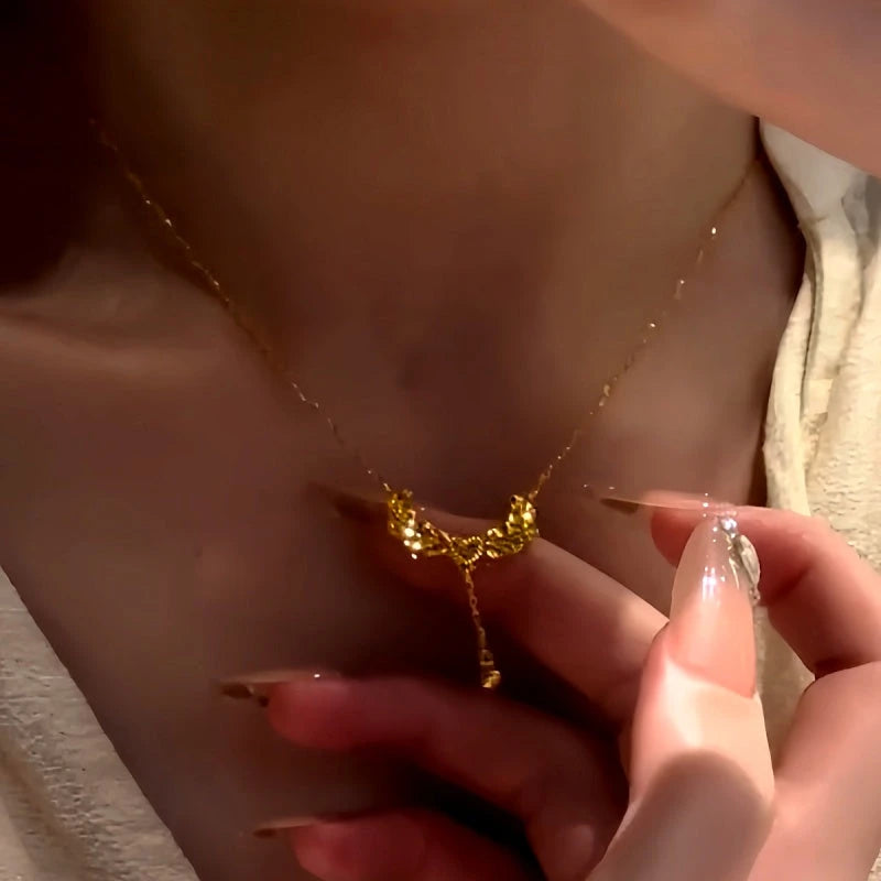 Close-up of the pendant and clasp on the Heart Wing Necklace