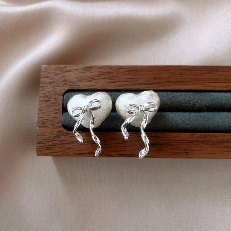 Angled view of the 14K Gold-Plated Heart Bow Stud Earrings