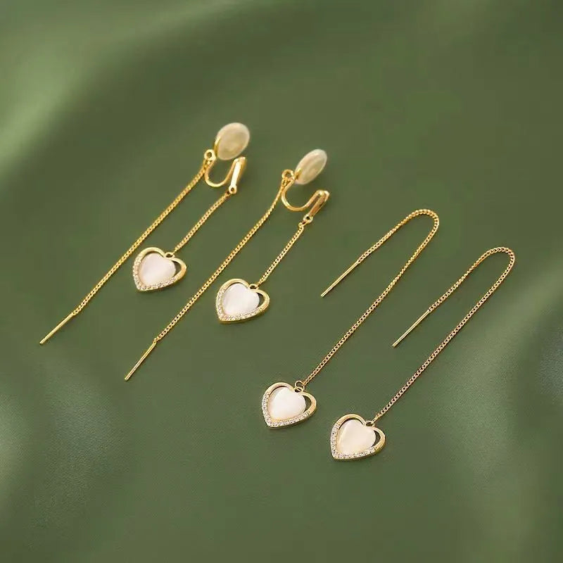 Angled view of the 14K Gold-Plated Heart Design Ear Clip And Threader Earrings