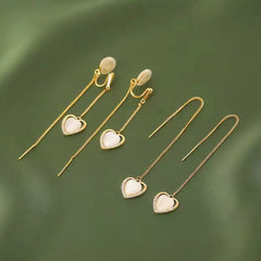 Angled view of the 14K Gold-Plated Heart Design Ear Clip And Threader Earrings