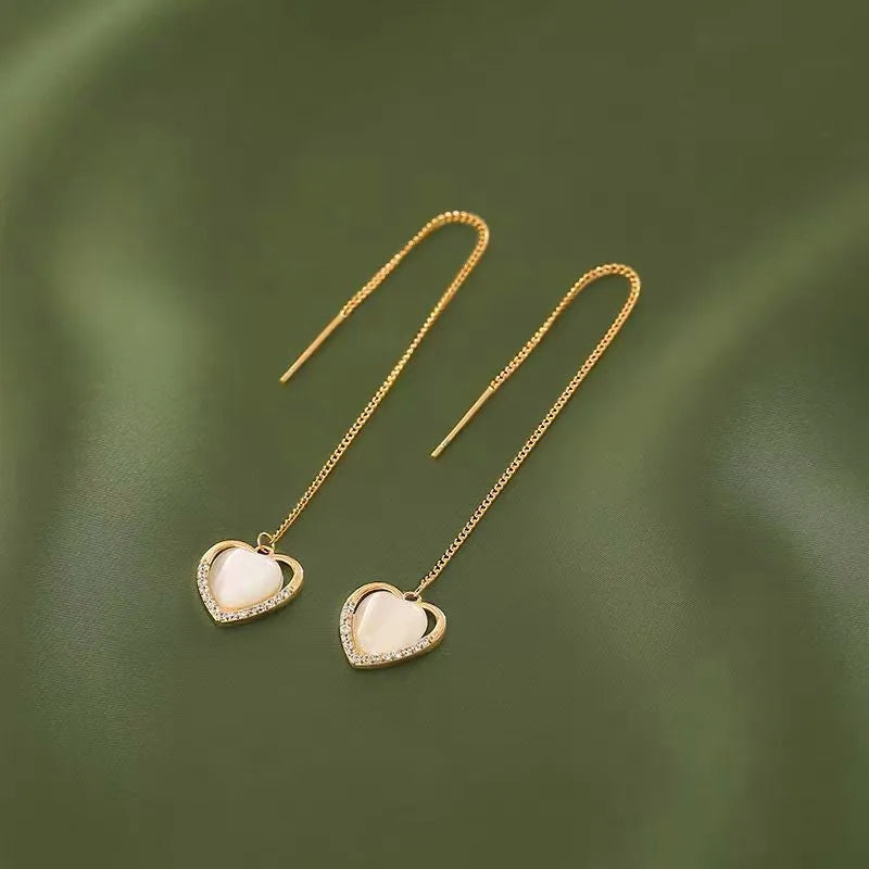 Model showcasing the dangle and style of the 14K Gold-Plated Heart Design Ear Clip And Threader Earrings