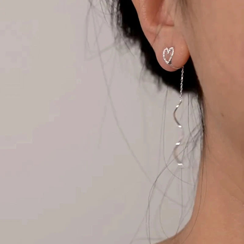 Angled view of the 14K Gold-Plated Heart Design Ear Clip Tassel Earrings